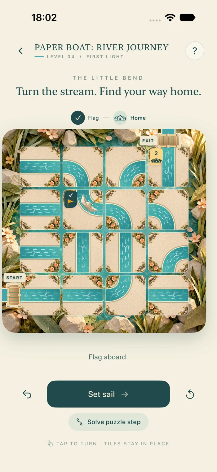 Actual gameplay: rotate turquoise waterways to guide a flag-carrying paper boat between the start and exit bridges.